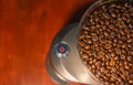 Coffee grinder with red start button, filled with fresh coffee beans and copy space in background for text, abstract, details Royalty Free Stock Photo