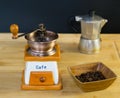 Coffee grinder and roasted coffee beans from the side in a wooden dish Royalty Free Stock Photo