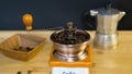 Coffee grinder and roasted coffee beans from the side in a wooden dishClose-up Italian coffee grinder, in which is poured with roa Royalty Free Stock Photo