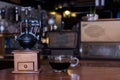 Coffee grinders and black coffee cups are on the table.