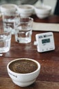 Coffee grounds with hot water in the ceramic cup on the table is preparing for professional Q Grader to testing and inspecting the Royalty Free Stock Photo