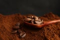 Coffee grounds and roasted beans on dark background, closeup Royalty Free Stock Photo