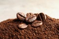 Coffee grounds and roasted beans on table