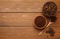 Coffee grounds and roasted beans on wooden table, flat lay. Space for text Royalty Free Stock Photo