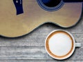 Coffee and guitar on wooden table