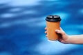 Coffee in hand. Blue background. A bright, attractive picture
