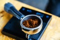 Coffee holder on electronic scales. The process of weighing ground coffee to prepare a drink. Close-up Royalty Free Stock Photo