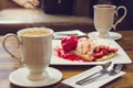 Coffee hot drink and ice cream strawberry crepe on wood table in Royalty Free Stock Photo