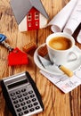 Coffee, House, Blueprint and Calculator on a Table