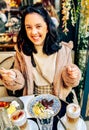 Young pretty brunette woman eating ice cream at the street cafe at Paris, France. Outdoor lifestyle portrait. Royalty Free Stock Photo