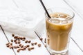 coffee ice cubes and beans with latte on white desk background Royalty Free Stock Photo