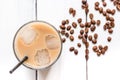 Coffee ice cubes and beans with latte on white desk background top view Royalty Free Stock Photo