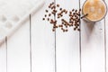 Coffee ice cubes and beans with latte on white desk background top view Royalty Free Stock Photo