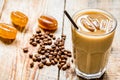 coffee ice cubes and beans with latte on wooden desk background Royalty Free Stock Photo