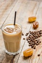 Coffee ice cubes and beans with latte on wooden desk background Royalty Free Stock Photo