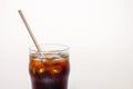 Coffee with ice in a glass cup with tube on a white background, a copy of the space Royalty Free Stock Photo