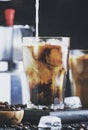 Coffee with ice and milk, brown table, selective focus and shallow DOF