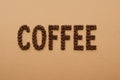 Coffee, the inscription is lined with coffee beans on background Royalty Free Stock Photo
