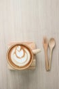 Coffee Late Art in wood cup on tray and ,with spoon and fork. Royalty Free Stock Photo