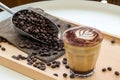 Coffee Latte Art. The coffee arts. Hot coffee in a white cup on wooden table. Hot chocolate Nutella latte art on wood table.