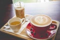 Coffee latte art red cup in the morning time Royalty Free Stock Photo