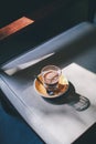 Coffee latte in glass cup, on a retro chair background in a coffee shop Royalty Free Stock Photo