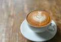 Coffee latte heart shaped leaves texture on wooden table