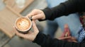 Coffee latte heart texture in hand of tourists