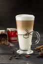 Coffee latte in tall glass cup and dessert on black background Royalty Free Stock Photo