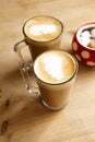 Coffee latte in two tall glasses and sugar bowl Royalty Free Stock Photo