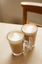 Coffee latte in two tall glasses woden table Royalty Free Stock Photo