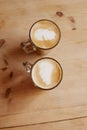 Coffee latte in two tall glasses on wood Royalty Free Stock Photo