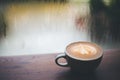 Coffee latte on wooden table, Raining, Outside Royalty Free Stock Photo