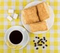 Coffee, lemon and sugar, plate with flaky biscuits on tablecloth Royalty Free Stock Photo