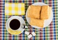 Coffee, lemon and sugar, plate with flaky biscuits on tablecloth Royalty Free Stock Photo