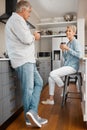 Coffee, love and couple with a senior man and woman drinking coffee together in the kitchen of their home. Retirement Royalty Free Stock Photo