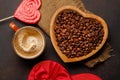 Coffee love: A cup and heart-shaped bowl with roasted beans Royalty Free Stock Photo