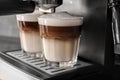 Coffee machine making latte, closeup Royalty Free Stock Photo