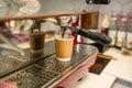 Coffee machine pouring coffee into a paper cup Royalty Free Stock Photo