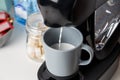 The coffee machine pours cappuccino into the cup. Coffee-make, coffee from the machine at home Royalty Free Stock Photo