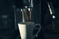 The coffee machine pours coffee into a white espresso cup. Close-up. Selected focus. Concept: A good start to the day is Royalty Free Stock Photo