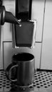 Coffee machine is preparing espresso- black and white