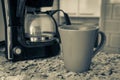 Coffee machine and red cup on table in the kitchen Royalty Free Stock Photo