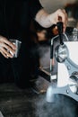 Coffee machine with steam in the process a cafe.Barista Cafe Making Coffee Preparation Service Concept.Barista is pouring coffee i Royalty Free Stock Photo