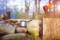 A coffee maker and an axe near a fire. Royalty Free Stock Photo