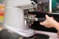 Coffee maker machine. Barista girl prepares coffee on the coffee machine Royalty Free Stock Photo