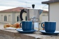 Coffee maker moka pot with roasted coffee beans. Space for text, horizontal. Breakfast concept. Pot and two blue cups of Royalty Free Stock Photo