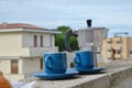 Coffee maker moka pot with roasted coffee beans. Space for text, horizontal. Breakfast concept. Pot and two blue cups of Royalty Free Stock Photo