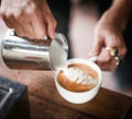 Coffee maker pouring the milk, Latte art Royalty Free Stock Photo