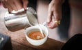 Coffee maker pouring the milk for make latte art Royalty Free Stock Photo